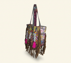 Close-up of Amber Fringe cowrie shell & tassel detail