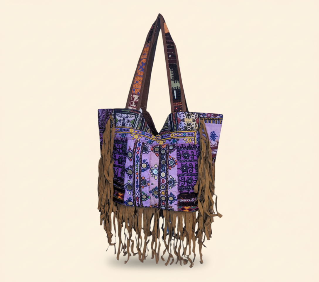Close-up of Emerald Fringe cowrie shell & tassel detail