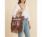 Model walking with Shell Tassel Indigo Fringe tote bag — lifestyle shot