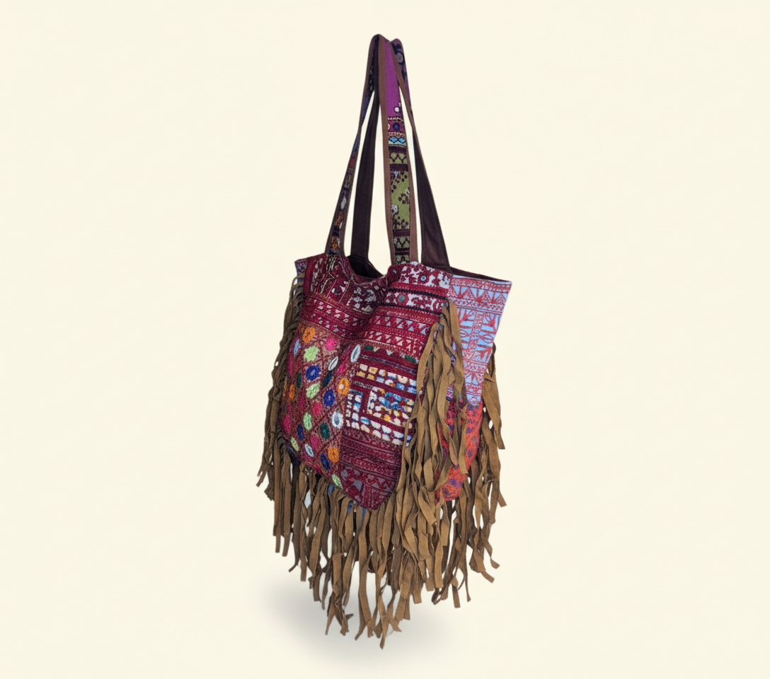 Close-up of Sapphire Fringe cowrie shell & tassel detail
