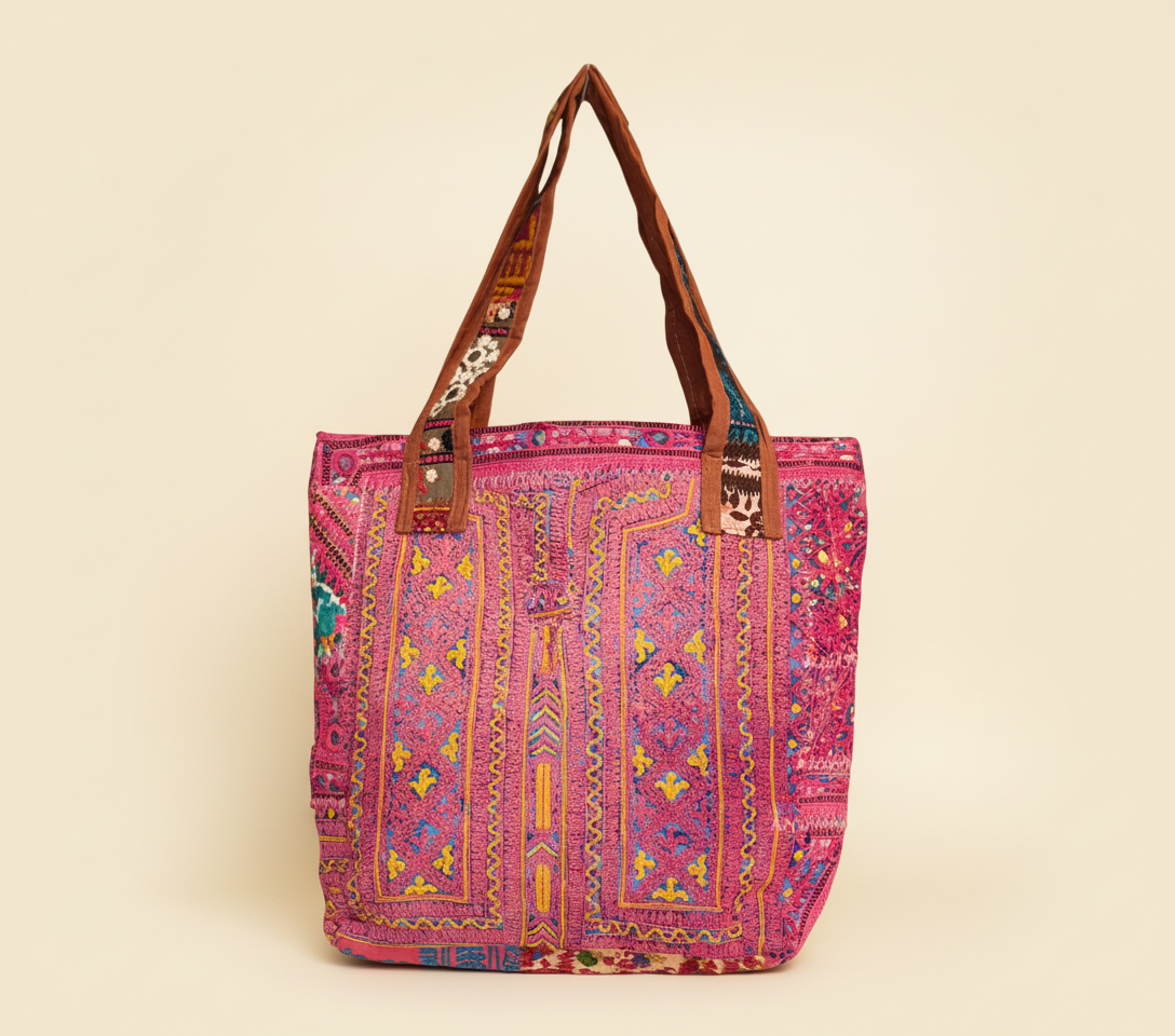 Close-up of Carnival Rose cowrie shell & tassel detail