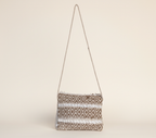 Model carrying Woven Earth Dune Lattice sling bag — boho style