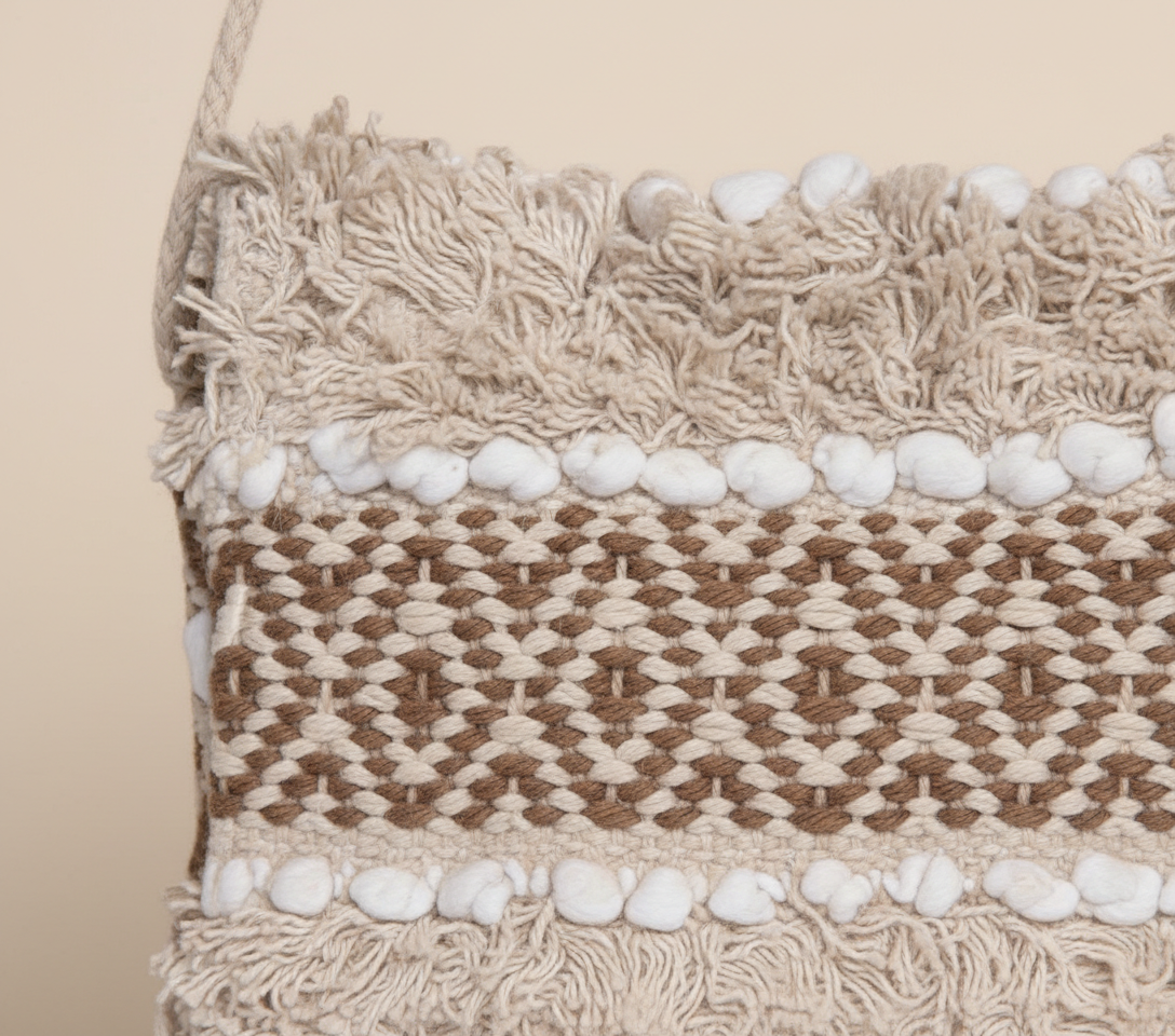 Model walking with Woven Earth Dune Lattice sling bag — lifestyle shot