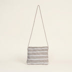 Close-up of Sand Chevron artisan weave texture on sling bag
