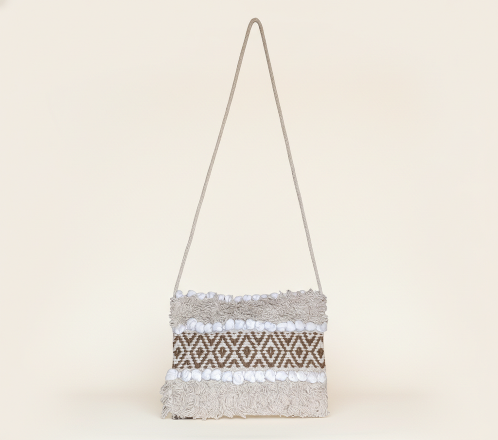 Model carrying Woven Earth Desert Grid sling bag — boho style