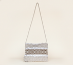 Model carrying Woven Earth Desert Grid sling bag — boho style