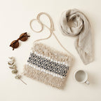 Model carrying Woven Earth Obsidian Weave sling bag — boho style