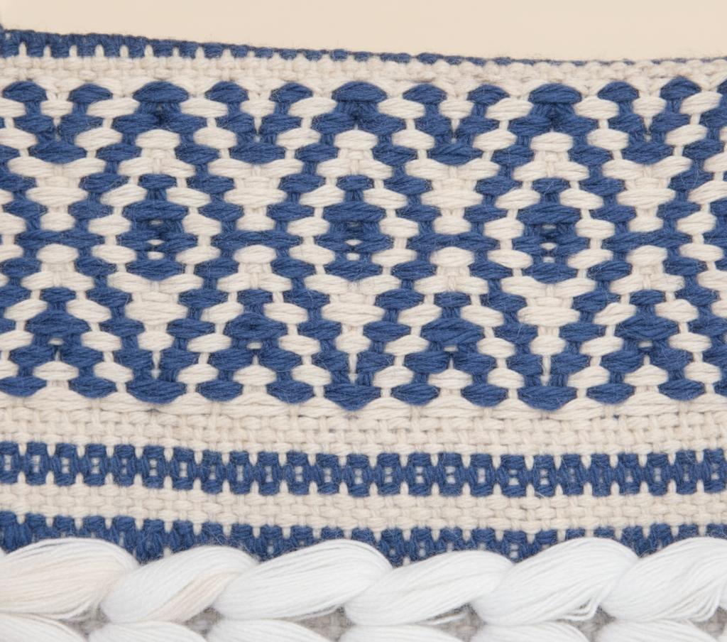 Model carrying Woven Earth Indigo Chevron sling bag — boho style