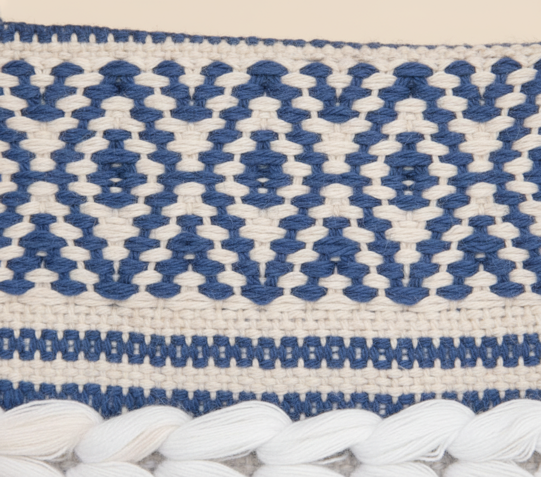 Model carrying Woven Earth Indigo Chevron sling bag — boho style