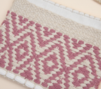 Close-up of Blush Lattice artisan weave texture on sling bag