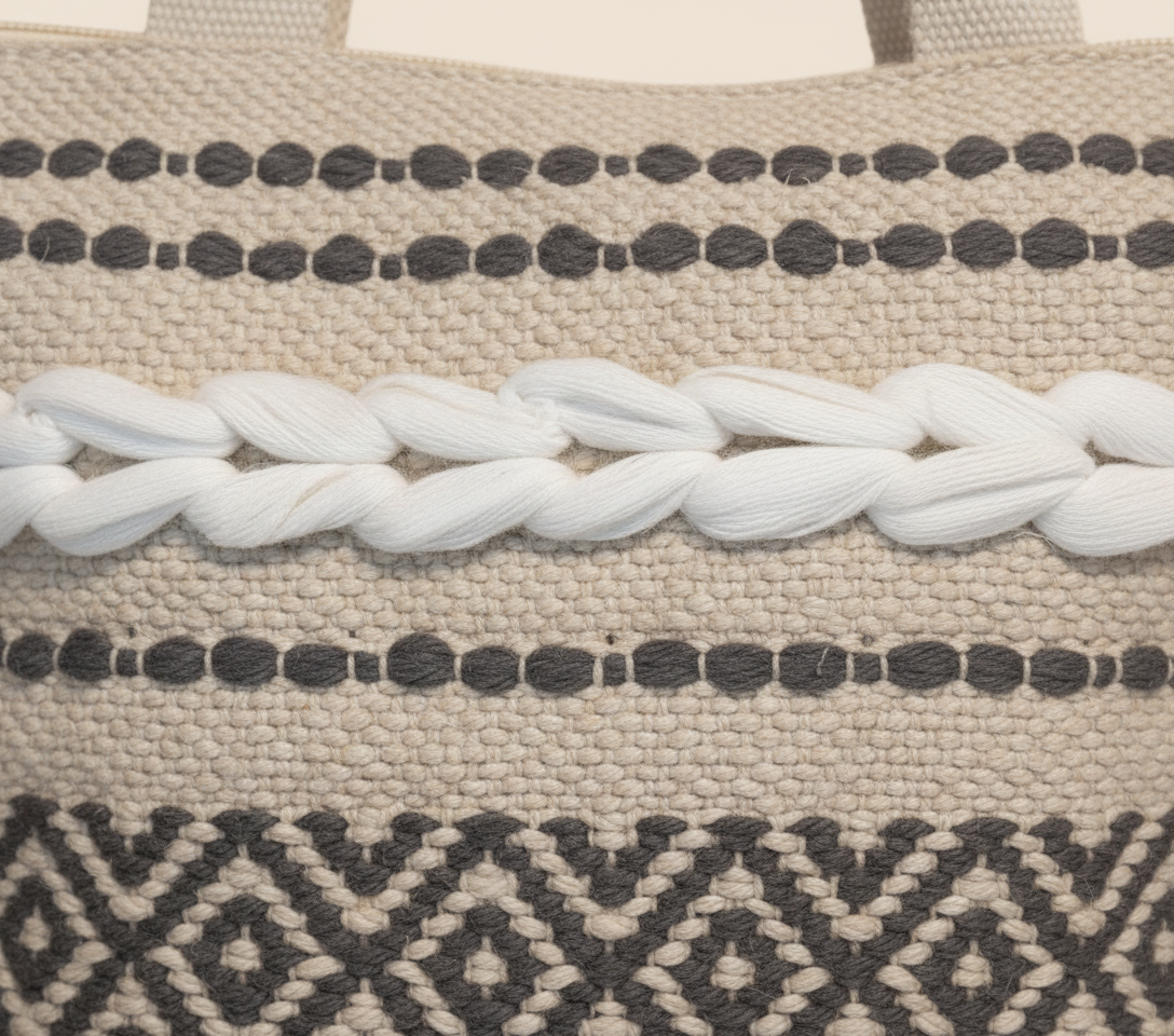 Model carrying Woven Earth Midnight Lattice tote bag — boho style