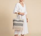 Model walking with Woven Earth Onyx Chevron tote bag — lifestyle shot